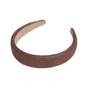 Handmade brown woven straw headband for women with chunky padded design on white background