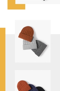 Close-up of cable knit beanie textures in orange, grey and navy blue winter colors