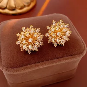 Gold plated starburst flower earrings with marquise cubic zirconia on velvet box