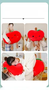 Detailed close-up of a large red apple plush pillow with cute embroidered smiling face