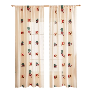 Sheer beige Christmas curtains with Santa and sleigh embroidery and scalloped lace edges