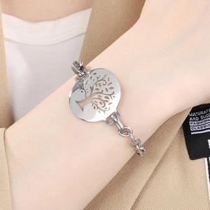Macro view of polished silver stainless steel tree of life pendant and link chain