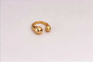 Detail of 18K gold plated adjustable C-shape ring featuring smooth pear drop ends