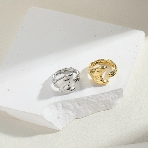 Minimalist vintage striped open rings in gold and silver finish on textured stone