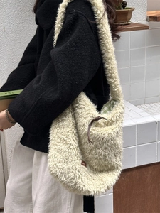 Creamy faux shearling tote bag with checkered lining and drawstring, stylish crossbody style