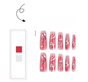 Macro detail of red gradient press-on nails with silver flame patterns and dots