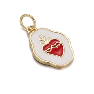 Close-up of 14K gold plated oval pendant with white enamel base and red heart design