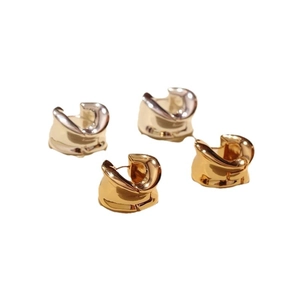 Minimalist irregular twisted gold and silver hoop earrings with high-polish metallic finish