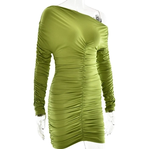 Close-up of green ruched long sleeve bodycon dress showing elastic fabric details