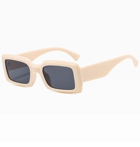 Detail view of the thick cream rectangular frame and dark grey lenses of these sunglasses
