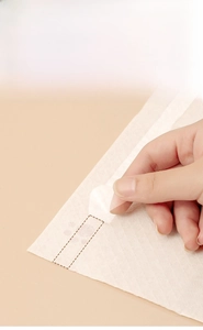 Macro shot of waterproof disposable placemat with four adhesive strips for non-slip grip