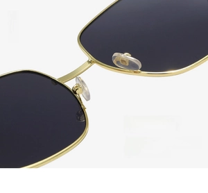 Detailed close-up of adjustable soft silicone nose pads on gold metal frame sunglasses