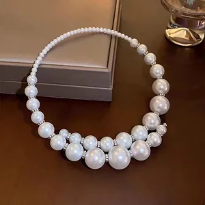 Detail of irregular pearl necklace with silver rhinestone spacers on jewelry box