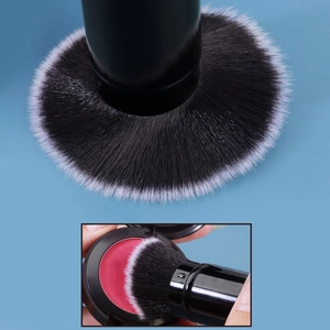 Macro detail of dense black and white gradient bristles picking up pink blush powder