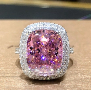 Macro view of cushion cut pink gemstone ring with double halo pavé setting