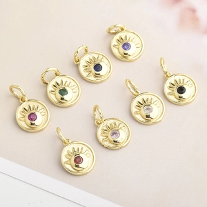 Detailed view of eight colorful zirconia evil eye charms with gold-plated sunburst finish