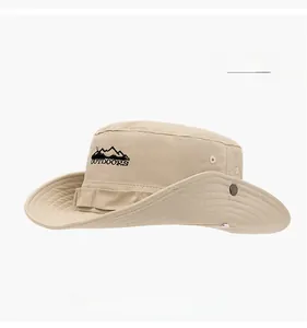 Detail of beige cotton tactical boonie hat with outdoors embroidery and metal snap buttons