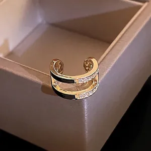 Double-layered gold-plated ear cuff with white zircon stones and black enamel finish