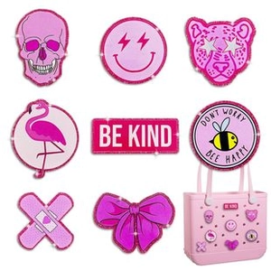 Pink glitter charms for rubber beach bags featuring smiley face, flamingo and bow decorations