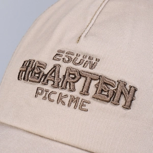 Beige baseball cap featuring detailed letter embroidery and contrast stitching details