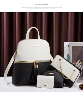 Detail view of four-piece black and white crossbody and backpack set with gold hardware