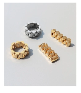 Detailed shot of heavy-duty link rings in gold and silver watch band style design
