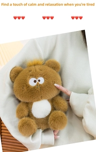 Close-up of soft brown plush bear toy with white belly being touched to show elasticity
