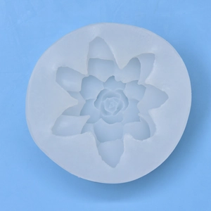 3D lotus shaped silicone mold for DIY candles and soaps on a blue background