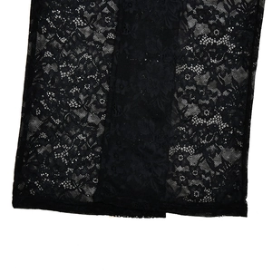 Detailed close-up of intricate black lace fabric with floral patterns on sleeveless jumpsuit