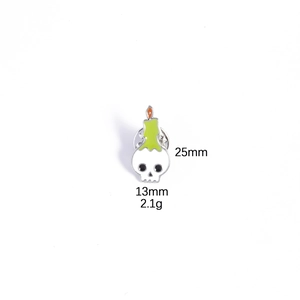 Macro shot of skull and candle enamel pin with 25mm height and 13mm width dimensions