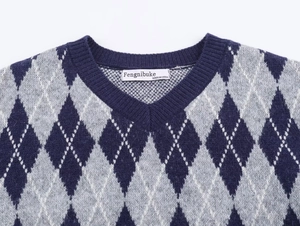 Detail of Argyle knit V-neck vest featuring navy and grey diamonds with white stitching