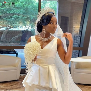 Close-up of bridal rhinestone tiara, long tassel earrings and matching branch necklace