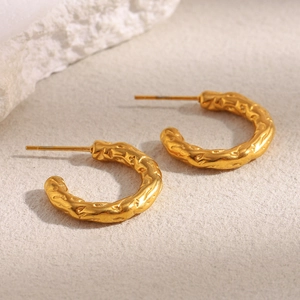 Detail of 18K gold plated earrings featuring a unique hammered irregular texture