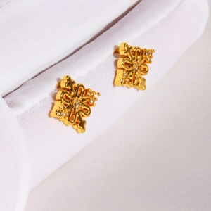 Exquisite golden hollow cross flower stud earrings with sparkling zircon accents