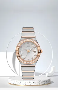 Close-up of luxury women watch with silver rose gold band and diamond bezel detail
