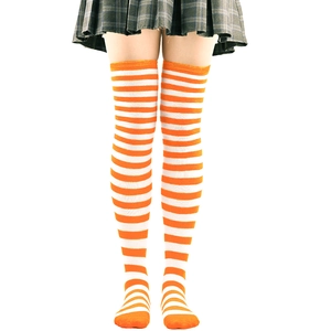 Close-up of orange and white striped over-knee high socks in soft knitted fabric