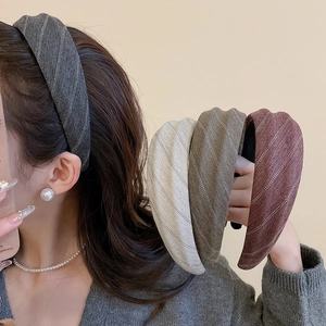 Detail of fabric headband with retro herringbone texture in four autumn colors