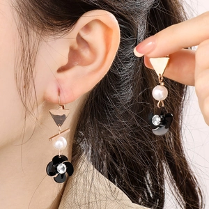 Elegant rose gold spiral drop earrings with white pearl and black floral crystal charm