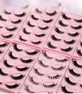 Close-up detail of 5 pairs of thick fox-style false eyelashes on pink trays