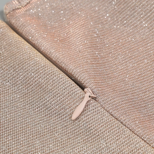Detailed macro view of champagne gold sequin fabric with matching hidden zipper closure