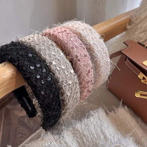 Detail of handmade sequin headbands in black beige pink with tassel accents
