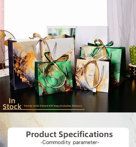 Close-up of marble pattern gift bag with gold foil details and silk ribbon handle