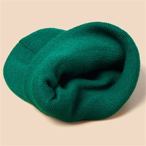 Winter dark green knitted beanie hat for men and women with warm elastic ribbed texture
