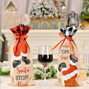 Detail of Christmas wine bottle covers featuring plaid patterns and Santa Claus motifs