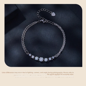 Macro detail of S925 sterling silver tag and sparkling stones on double-layer bracelet
