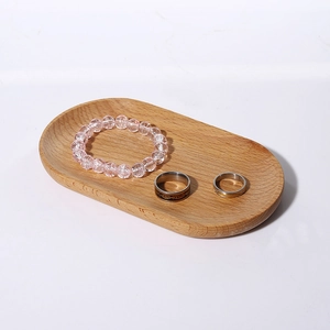 Oval solid wood jewelry tray featuring natural wood grain for rings and bracelets