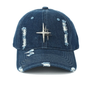 Distressed dark blue denim baseball cap featuring metal star studs and ripped fringe details