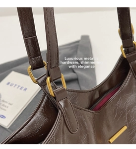 Detail of soft leather texture with gold square buckle and interior lining on tote bag