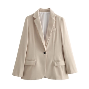 Detailed close-up of a beige blazer featuring classic notched lapels and flap pocket design