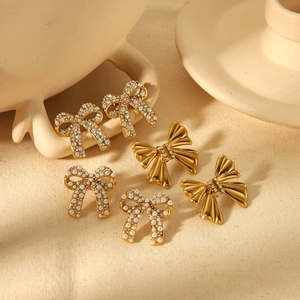 Three pairs of elegant bow-knot earrings with rhinestones and pearls in gold finish